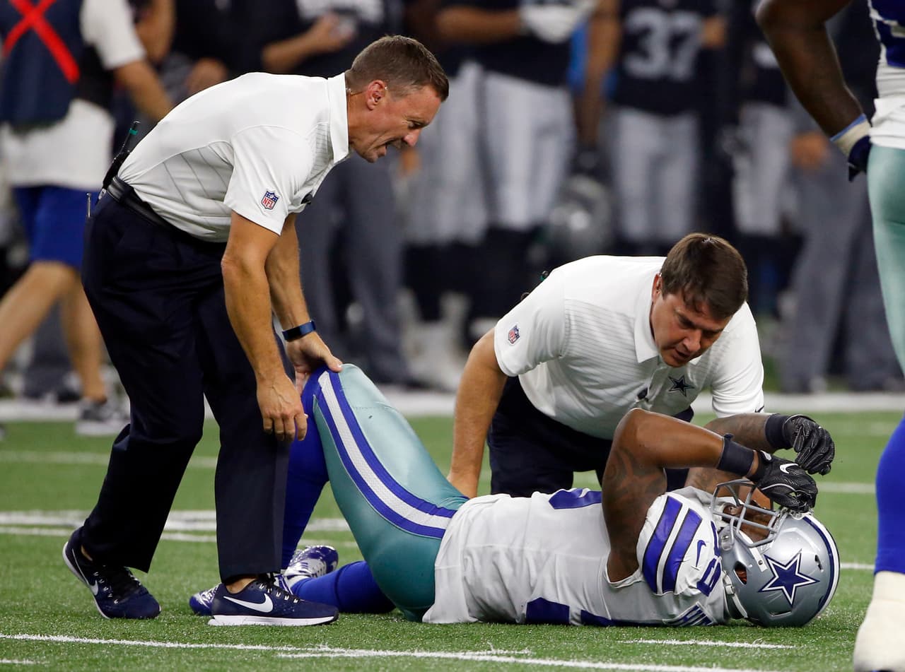 Dallas Cowboys team medical staff assist linebacker Anthony Hitchens (59) after Hitchens suffered an unknown injury in the first half of a preseason NFL football game against the Oakland Raiders on Saturday, Aug. 26, 2017, in Arlington, Texas. (AP Photo/Ron Jenkins)