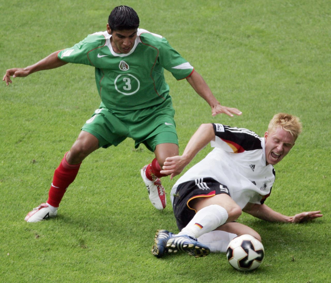 LEIPZIG, Germany: FILES - A file picture taken on 29 June 2005 shows Mexican defender Carlos Salcido (L) and Gerrman forward Mike Hanke during the Confederations Cup third place final football match Germany vs Mexico at the Zentral stadium in Leipzig. Hanke, sent off during the third-place play-off in the Confederations Cup 2005, has been suspended for the first two matches of the 2006 World Cup finals, the German team said on 21 July 2005. AFP PHOTO FRANCOIS GUILLOT (Photo credit should read FRANCOIS GUILLOT/AFP/Getty Images)