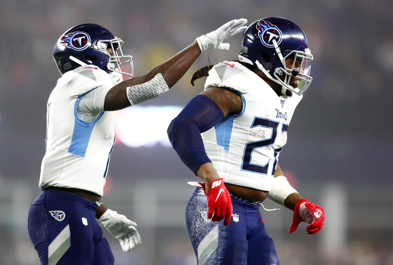 FOXBOROUGH, MASSACHUSETTS - JANUARY 04: Derrick Henry #22 of the Tennessee Titans reacts with teammate A.J. Brown #11 in the AFC Wild Card Playoff game at Gillette Stadium on January 04, 2020 in Foxborough, Massachusetts. The Tennessee Titans won 20-13. (Photo by Adam Glanzman/Getty Images)