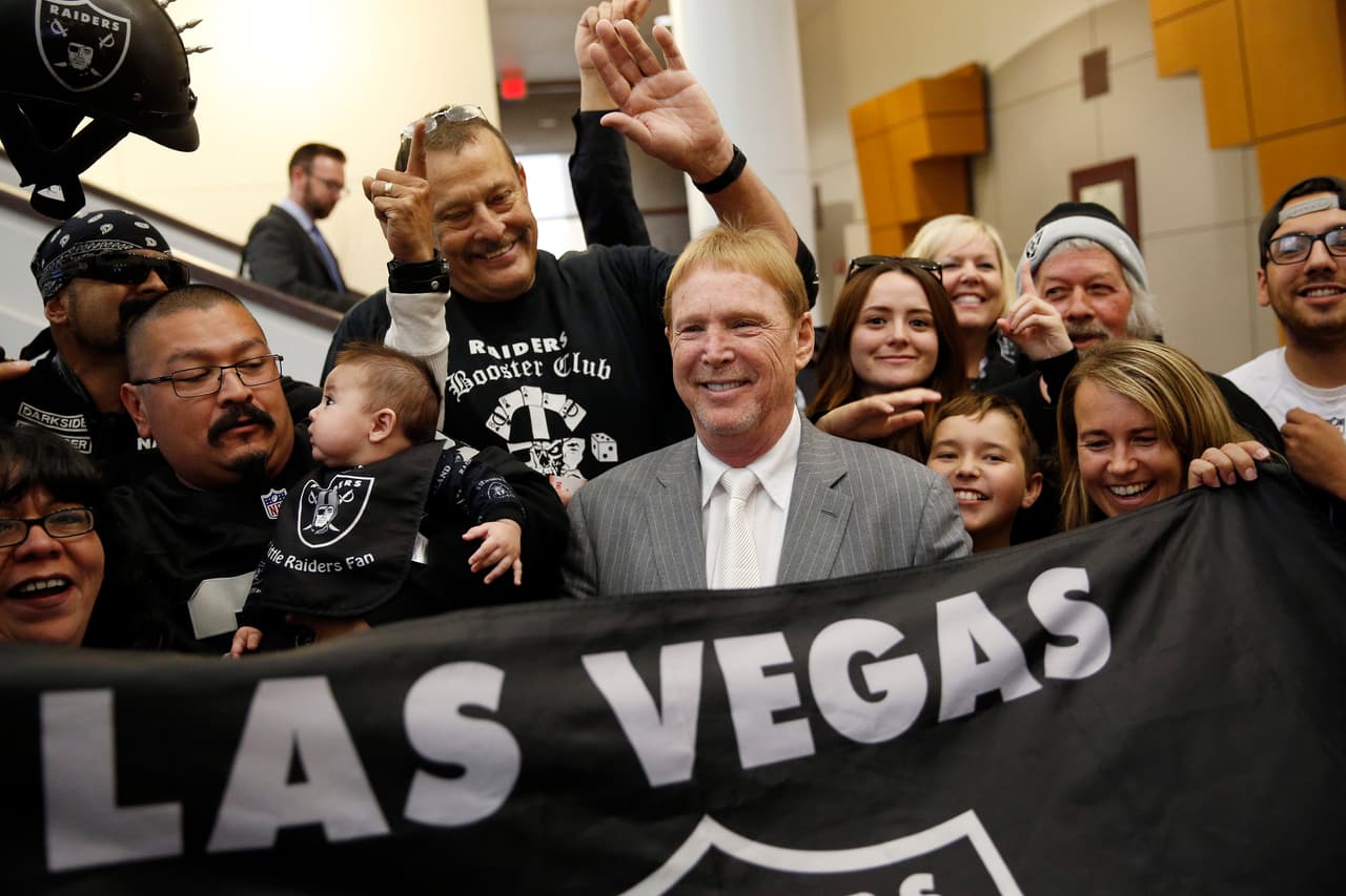 FILE - In this April 28, 2016, file photo, Oakland Raiders owner Mark Davis, center, meets with Raiders fans after speaking at a meeting of the Southern Nevada Tourism Infrastructure Committee in Las Vegas. Nevada lawmakers convene Monday, Oct. 10, 2016, to consider raising taxes in the Las Vegas area to help fund a $1.9 billion football stadium, a $1.4 billion convention center expansion and more police officers to protect the additional tourists. (AP Photo/John Locher, File)